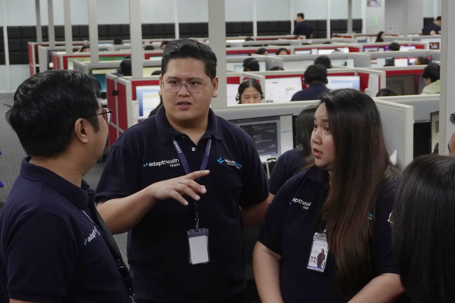 Healthscope colleagues talking together beside their workstations